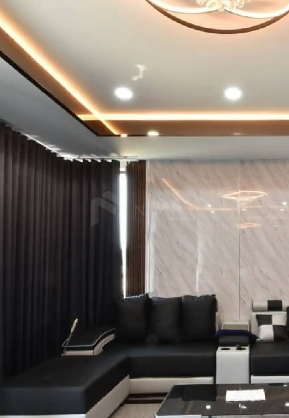 Shiny gold stainless steel trim accents modern living room with black sofa, marble wall, and elegant lighting features for luxury interior design. Perfect for stylish decorative and architectural applications.