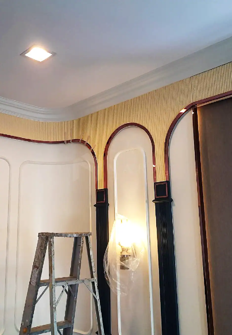 Bright gold stainless steel corner trim accents in interior design with elegant arch details and decorative moldings, providing a modern luxurious look.