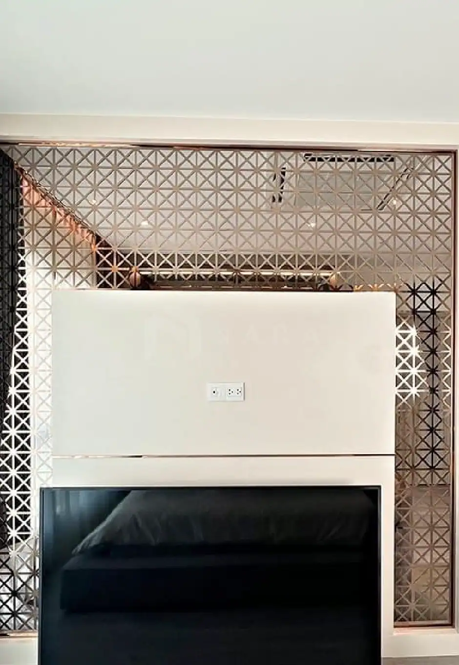 Shiny gold stainless steel decorative trim with geometric pattern for home interior design.