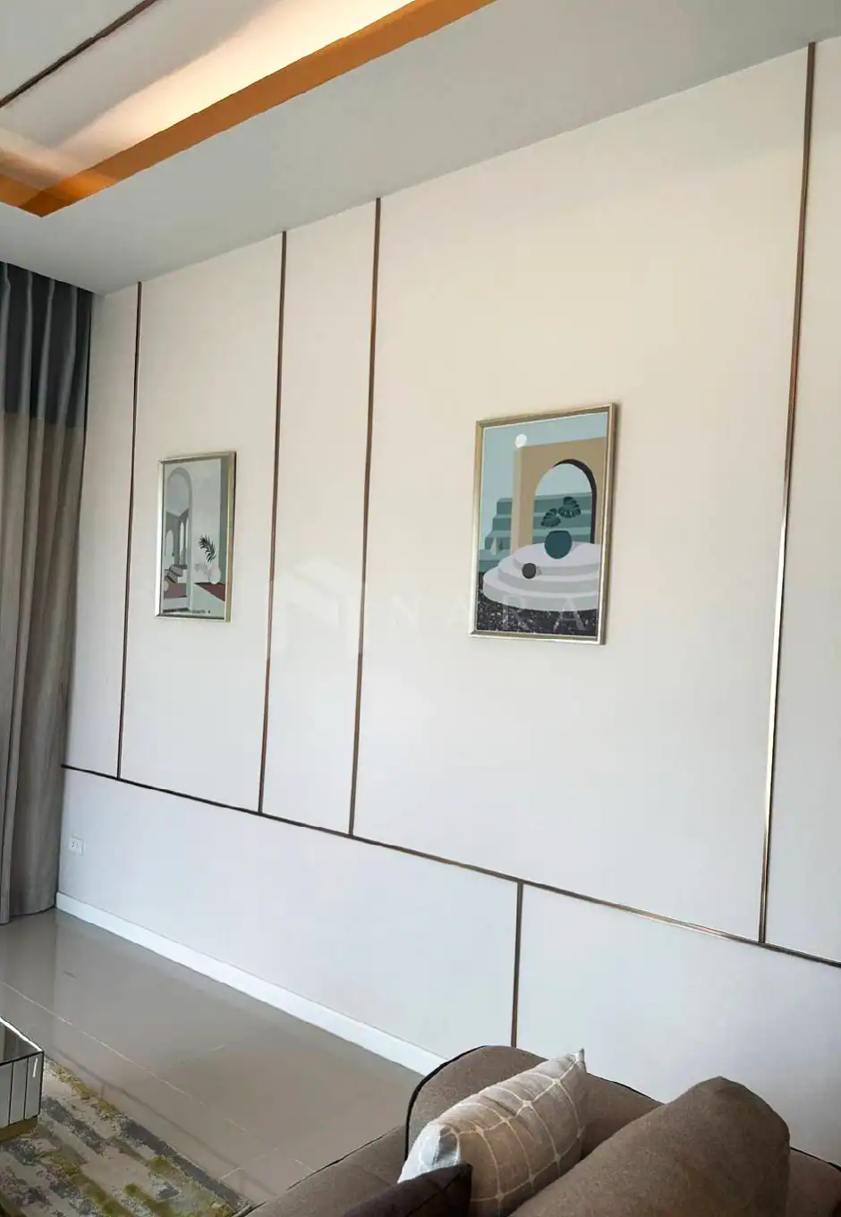 Shiny gold stainless steel wall trim in modern interior design for elegant room accents.