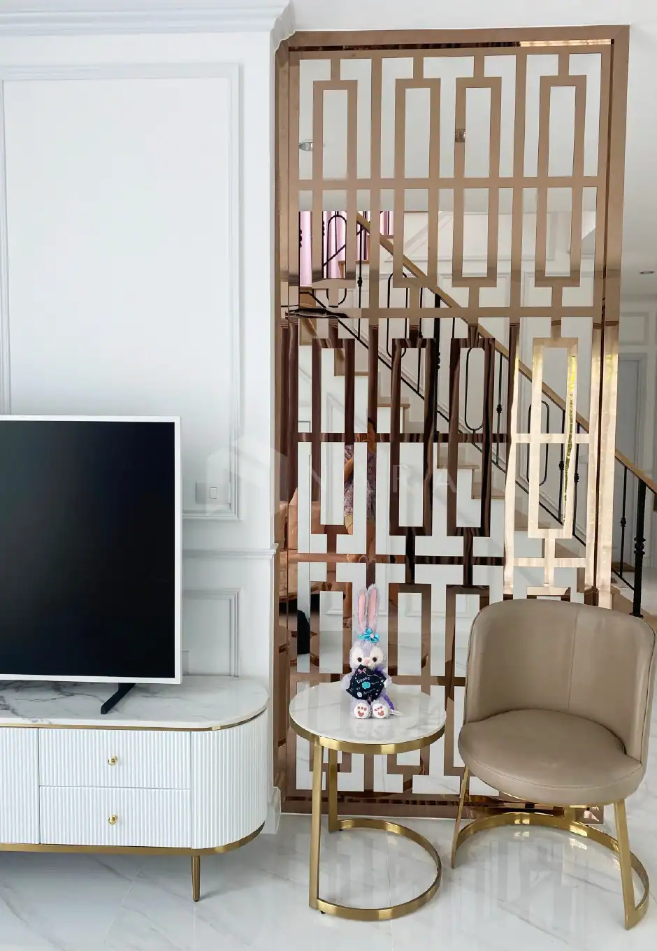 1. Golden stainless steel decorative divider panel used as a stylish room partition in modern interior designs.