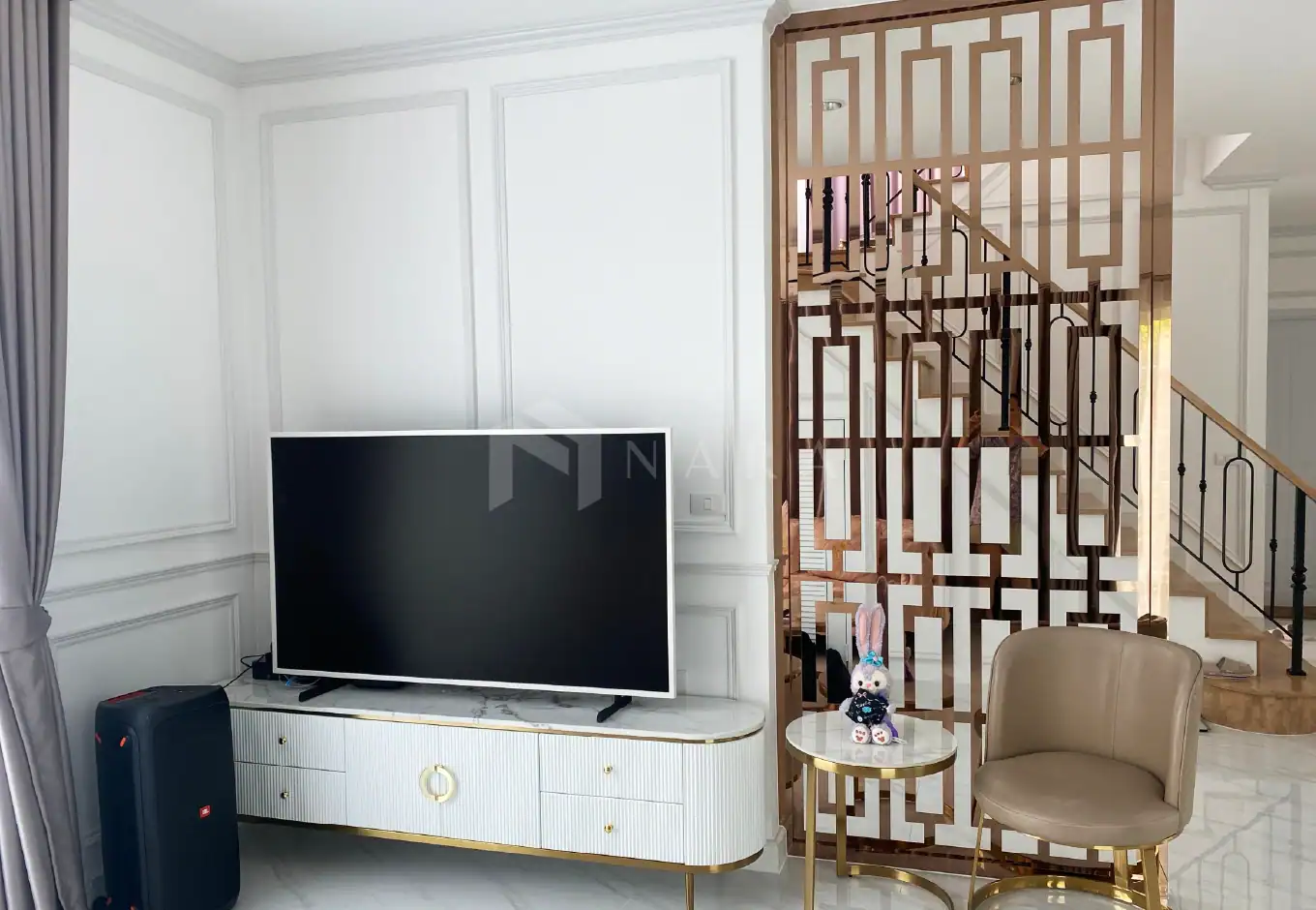 Premium gold-colored stainless steel trim and decorative lattice partition design enhancing modern interior aesthetics and creating a stylish, sophisticated living space.
