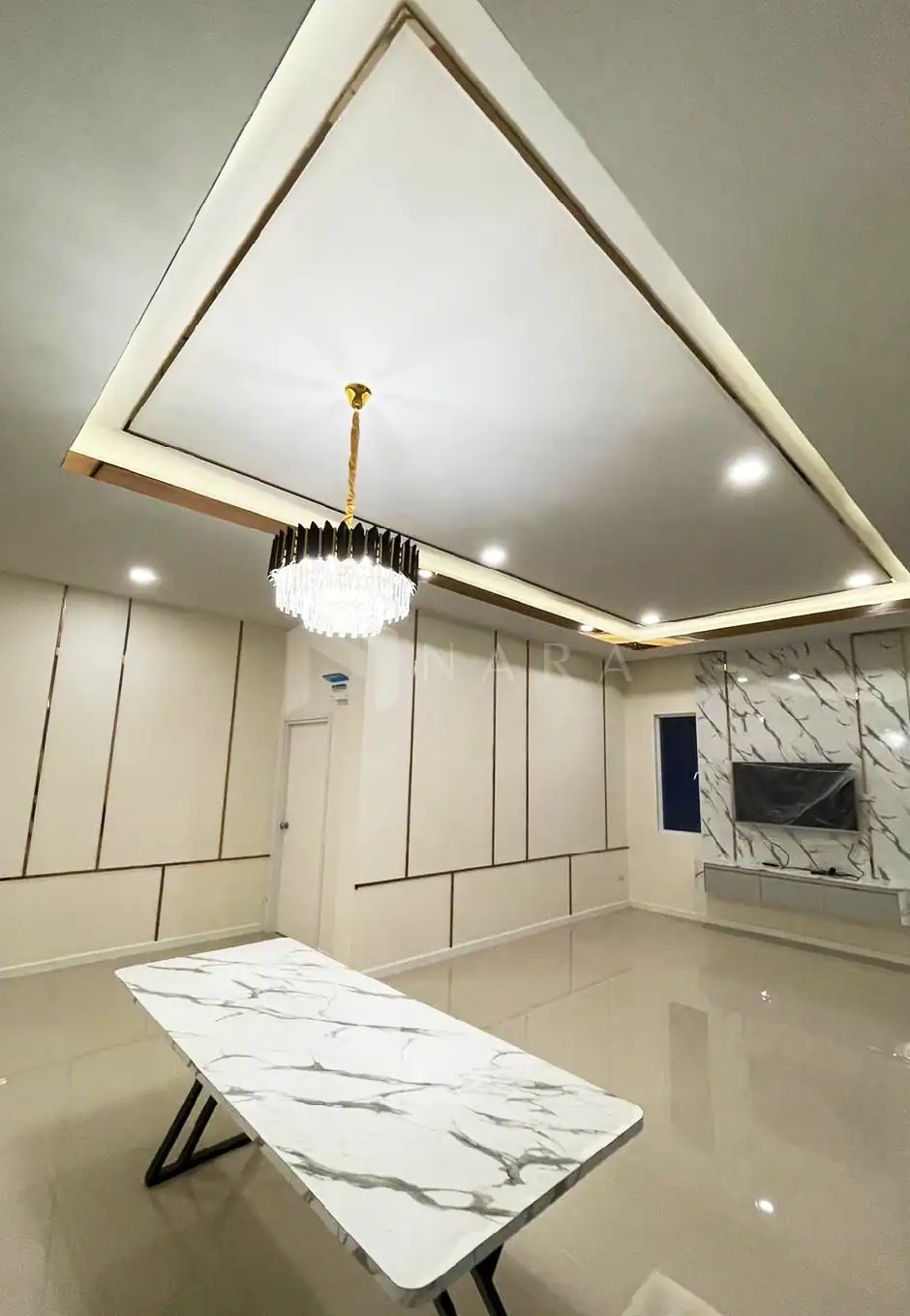 1. Gold stainless steel trim and wall accents in a modern living room with marble features and elegant lighting.