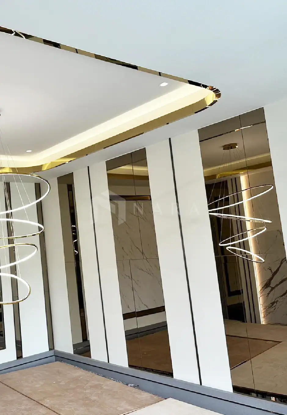 Luxurious gold-colored stainless steel trim and decorative stainless steel edges with modern LED lighting in contemporary interior design.