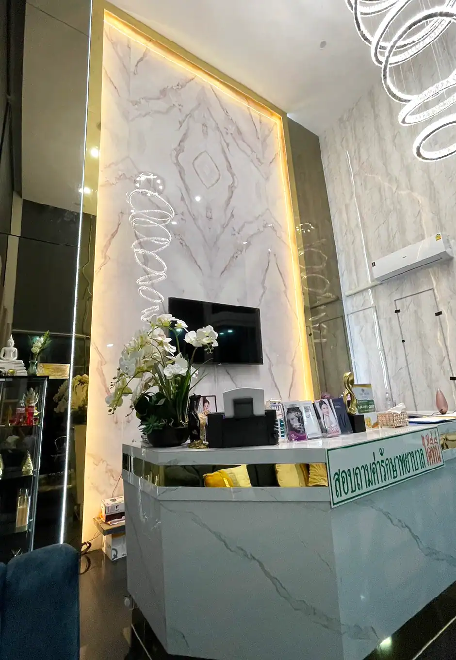 Shiny gold stainless steel trim and decorative accents in a modern interior with marble walls and elegant lighting, enhancing the luxurious ambiance of the space.
