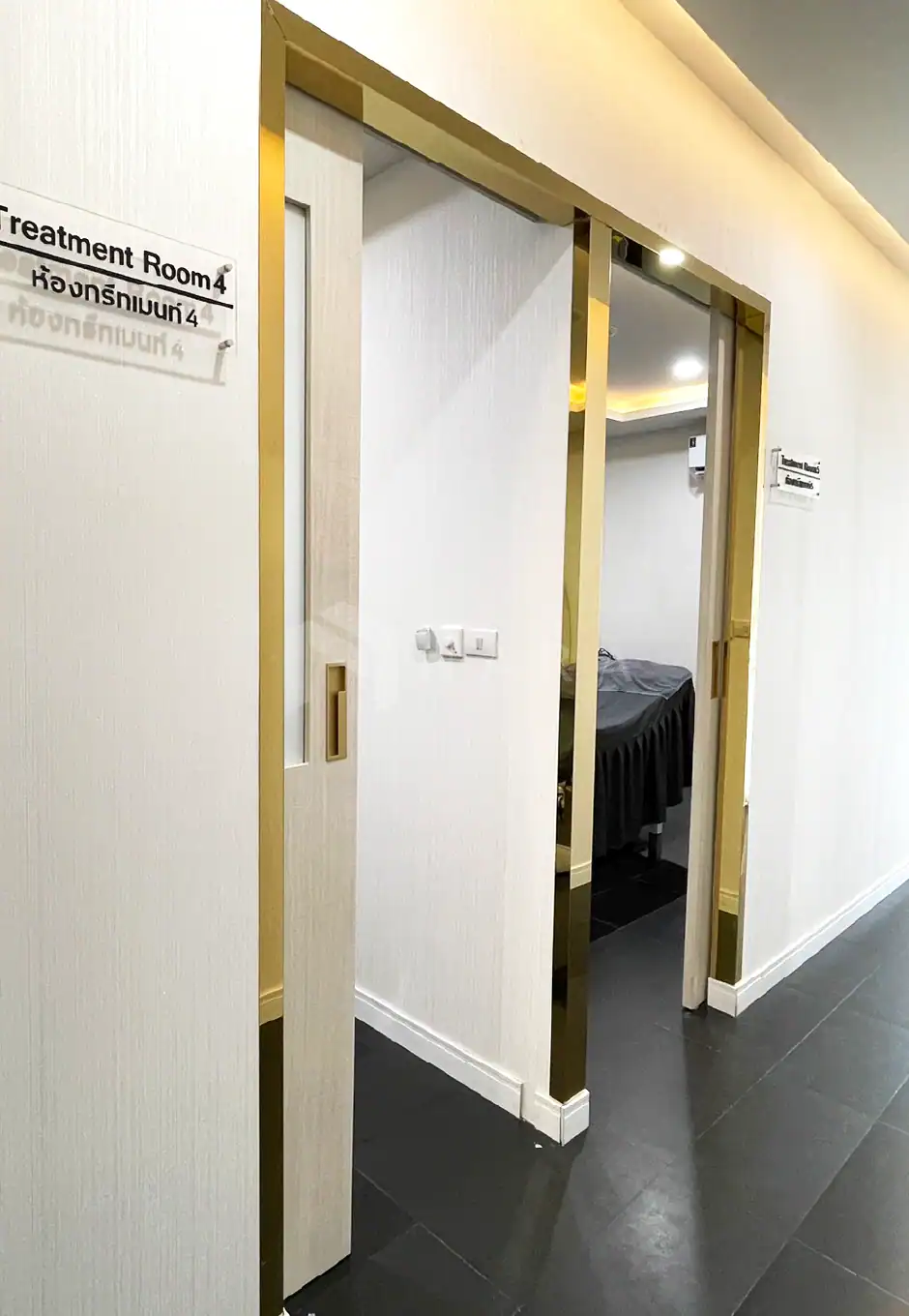 Shiny gold stainless steel corner trims framing a door in a modern interior, adding a luxurious touch to the space with sleek, durable stainless steel decorative accents.