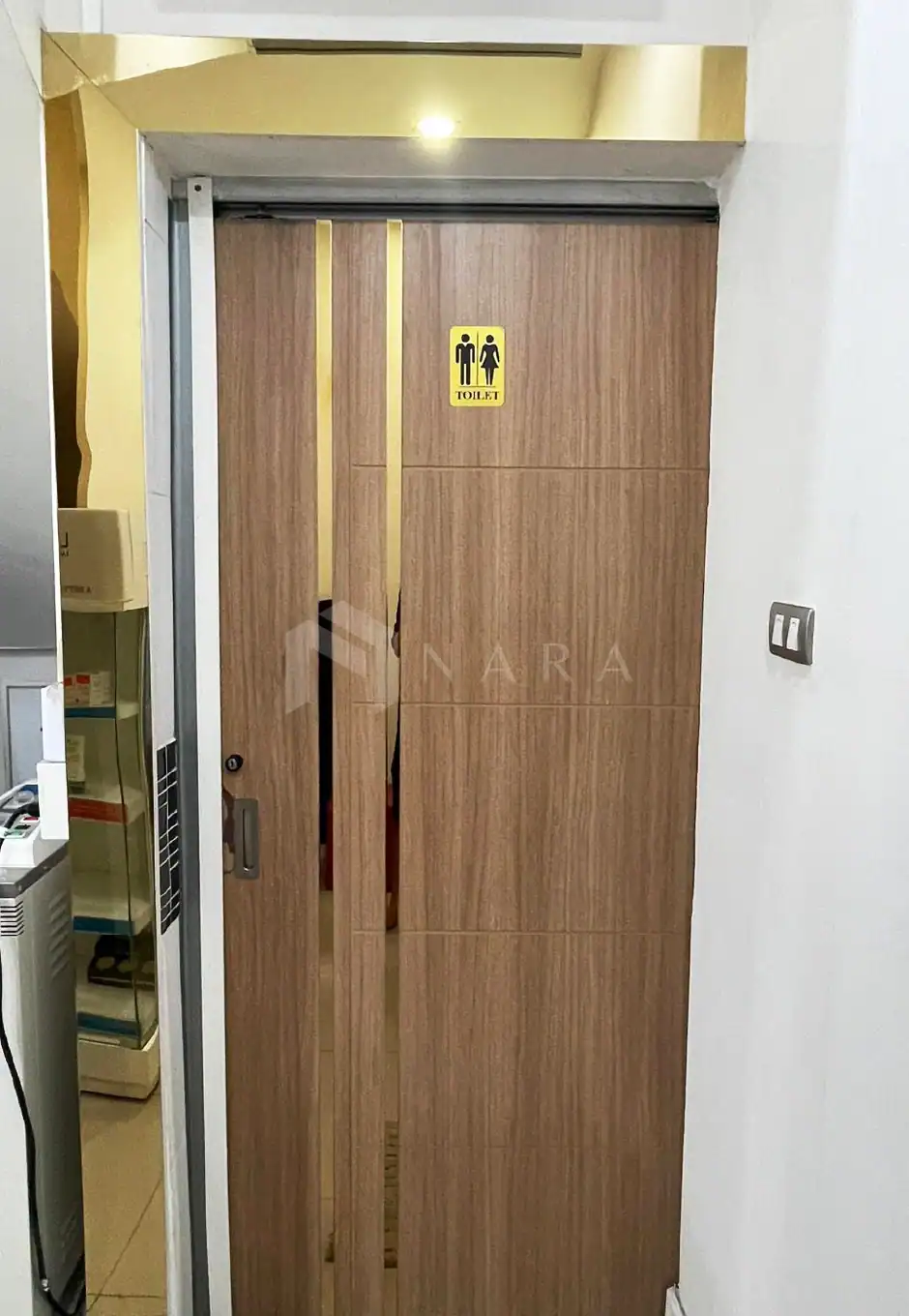 Gold-colored stainless steel door frame accentuates modern aesthetics for restroom entrances, combining durability with stylish design to elevate interior decor.