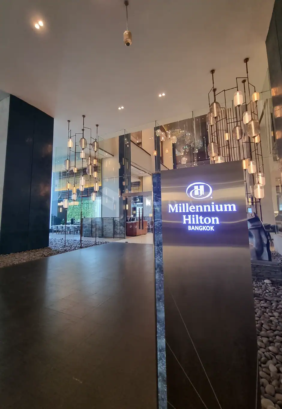 Bright gold stainless steel decorative trim used for modern interior design at Millennium Hilton Bangkok hotel entrance. The stylish accents enhance contemporary luxury aesthetics.