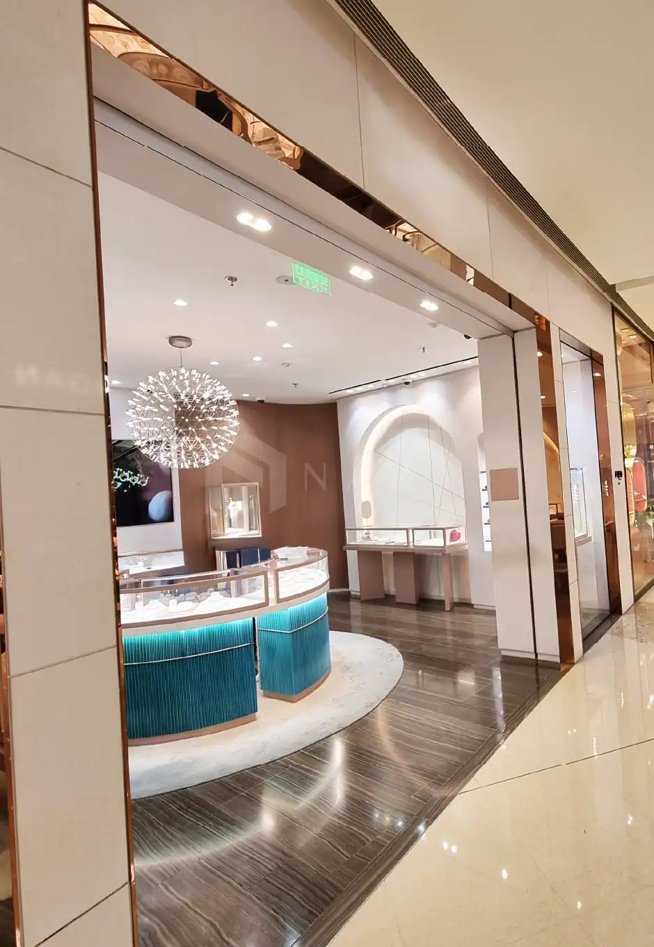 Shiny gold stainless steel decorative trim and accessories enhancing the luxurious store interior design. Perfect for upscale retail and jewelry shops with modern, elegant finishes.