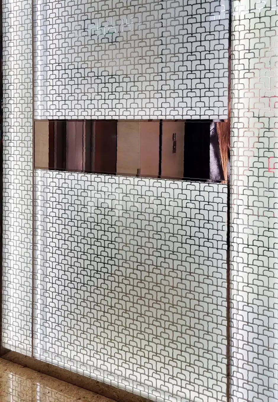 Shiny stainless steel decorative corner trim with a golden hue for interior design accents.
