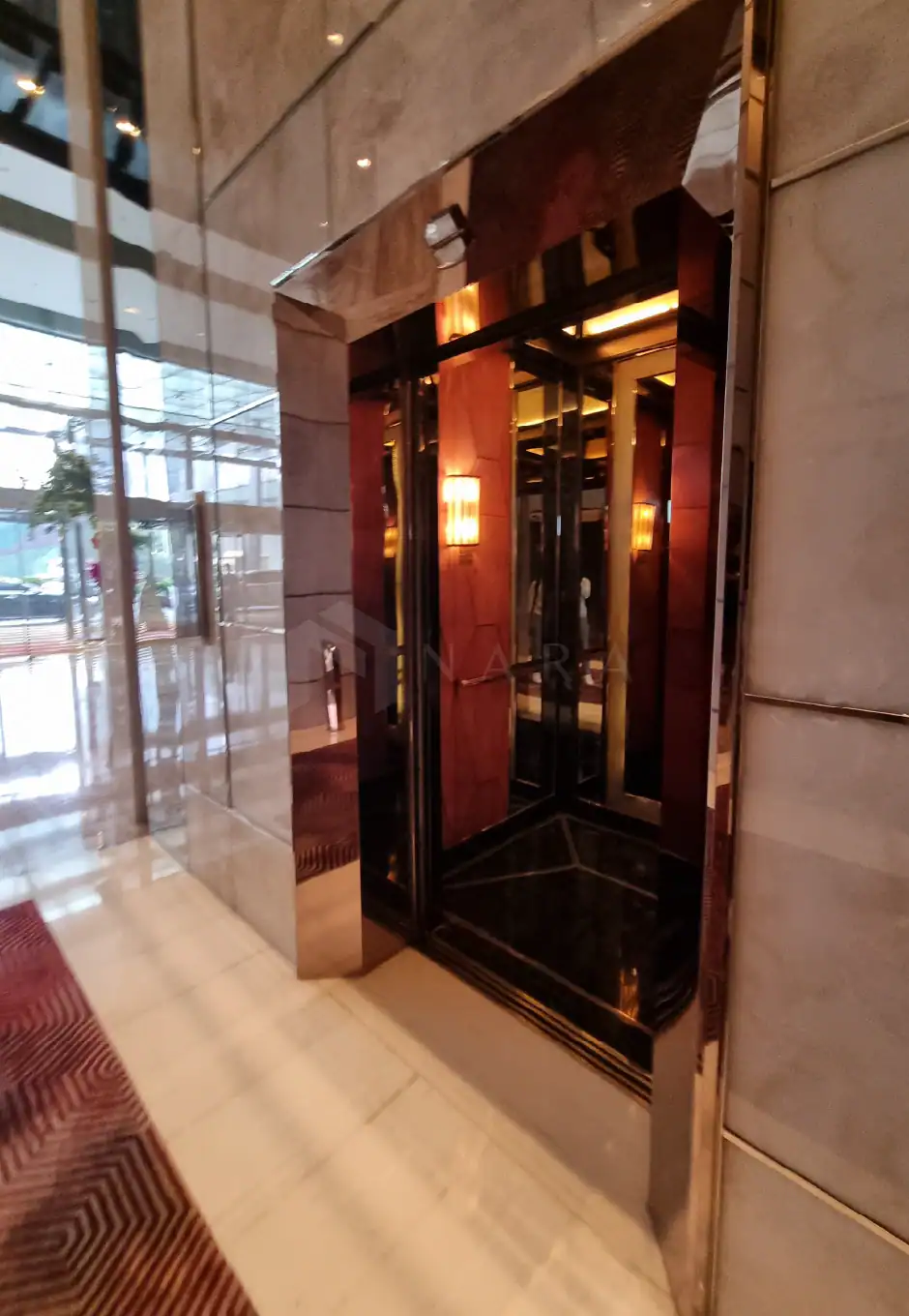 Shiny gold stainless steel corner decorative trim inside a modern building, enhancing aesthetic appeal with sleek, polished finish. Perfect for luxurious interiors and upscale design projects.