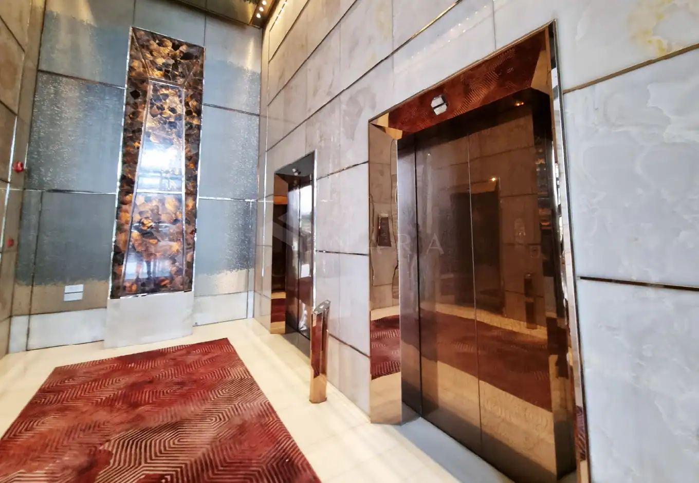 1. Shiny gold stainless steel elevator doors with decorative stainless steel corner trims in a modern building.