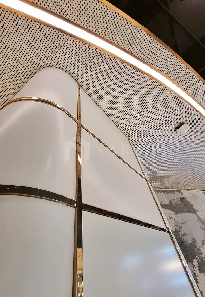 Shiny gold stainless steel corner trims and wall panels with modern design, featuring smooth surfaces and metallic accents, ideal for upscale interior decor and architectural finishing.