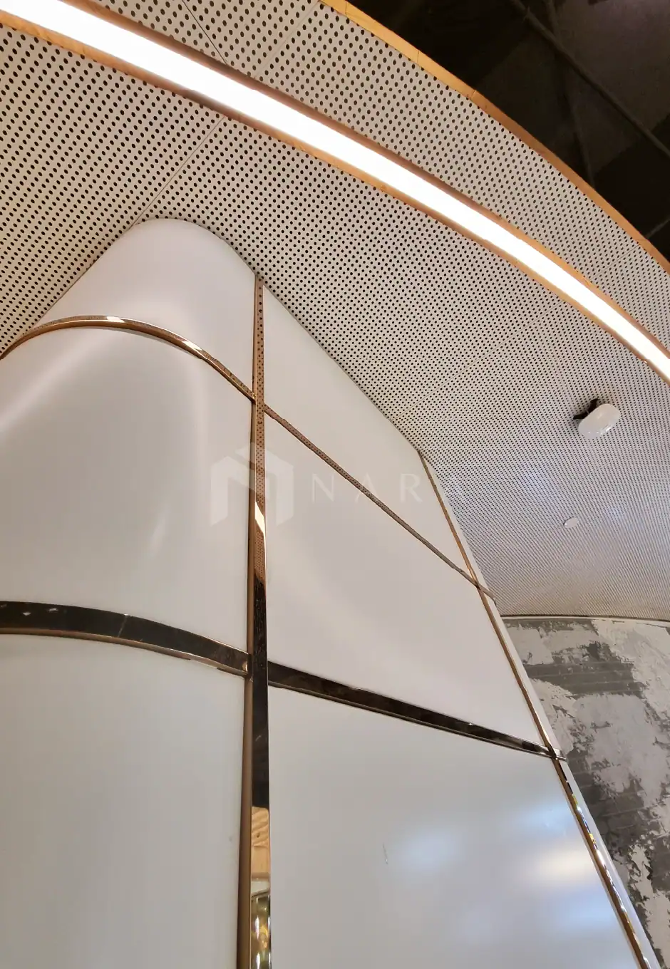 Shiny gold stainless steel corner trims and wall panels with modern design, featuring smooth surfaces and metallic accents, ideal for upscale interior decor and architectural finishing.