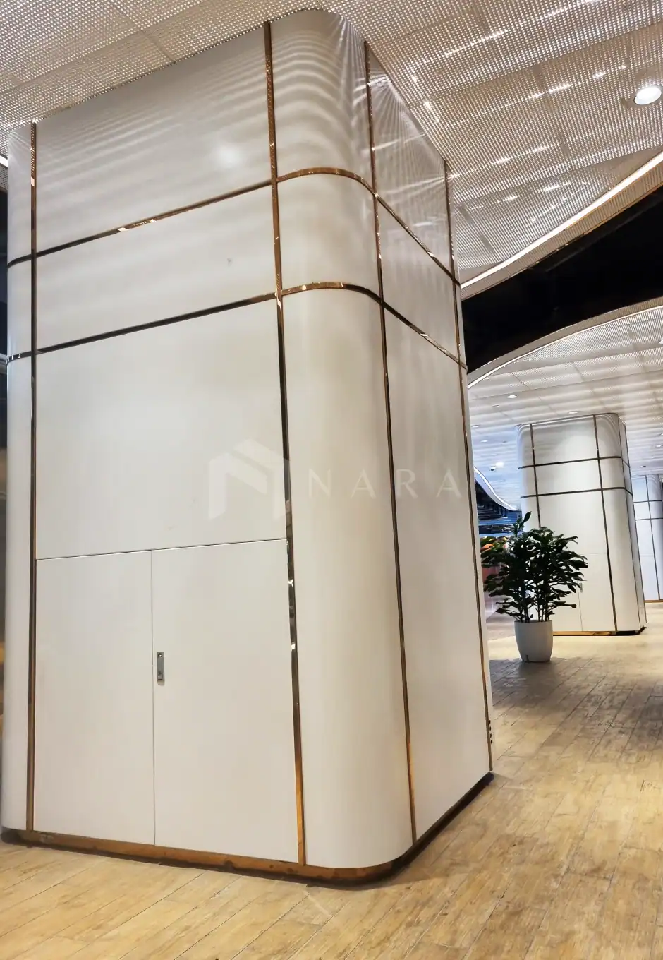 1. Gold stainless steel trim and decorative accents on sleek white panels in modern architectural design.