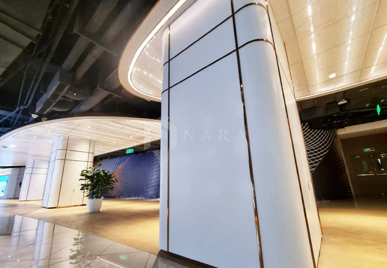 Shiny gold stainless steel trims used for decorative wall and column accents in modern commercial interior design.