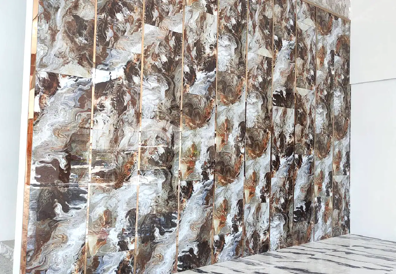 Luxurious gold-colored stainless steel wall decor with marble-like patterns, ideal for modern interiors and stylish architectural accents. Perfect for creating elegant, upscale spaces with durable stainless steel finishes.
