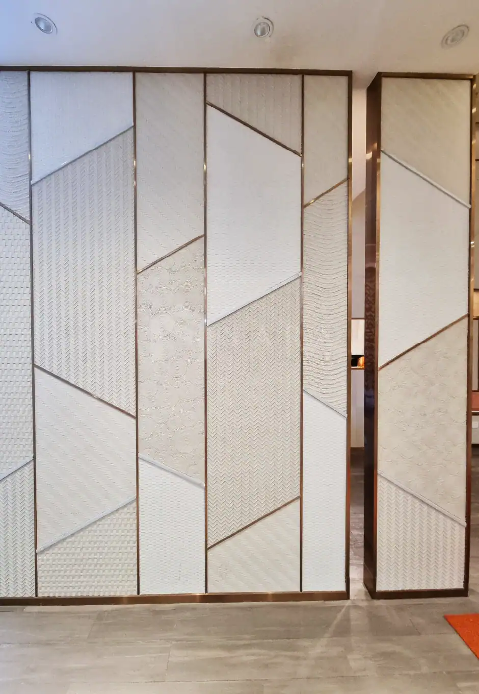 Luxurious white textured wall panels with gold-colored stainless steel trim, designed for modern interior decor and wall accents, showcasing elegant geometric patterns and premium materials.