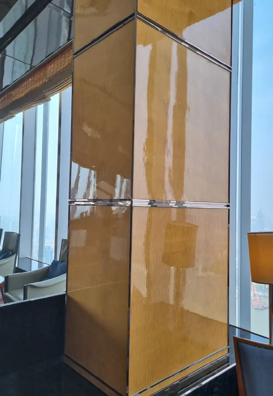 Shiny gold stainless steel wall panel with decorative trim, used for modern interior accents in luxury commercial or residential spaces. Reflective surface enhances lighting and aesthetic appeal.