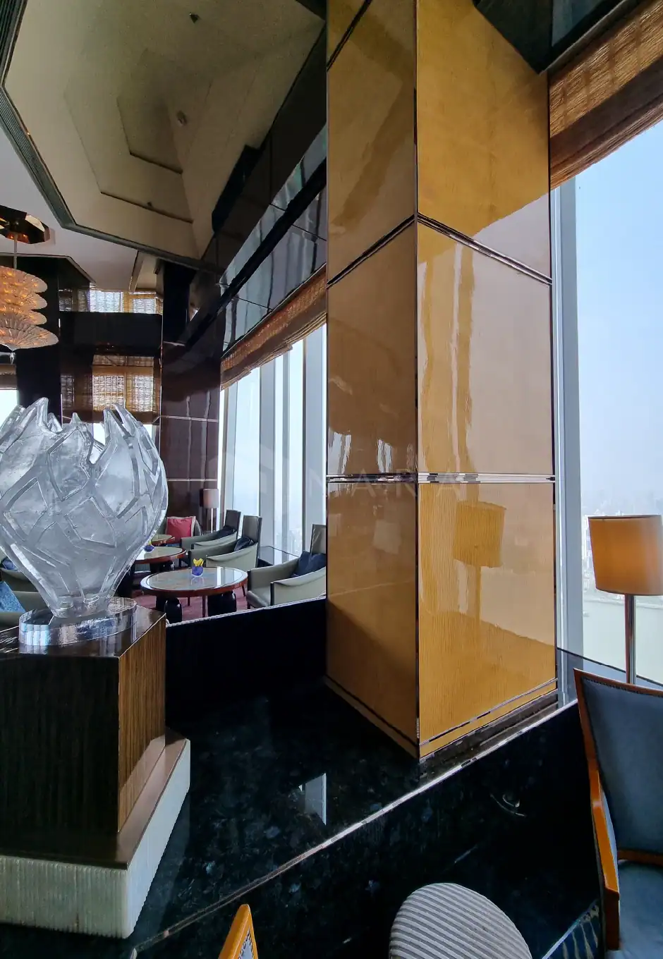 Shiny gold stainless steel decorative trim and wall panels in a modern luxurious interior space. High-end stainless steel accents add elegance and sophistication to the room's décor.