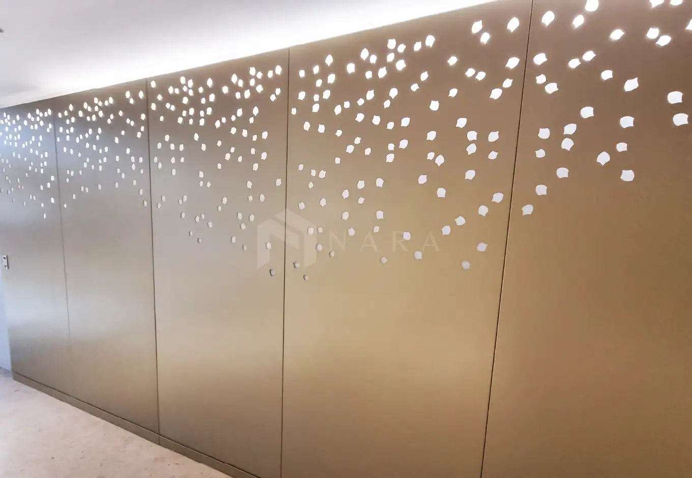 1. Gold-colored stainless steel wall panel with decorative perforations for modern interior design.